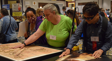 Three NFB members check out a display in the exhibit hall.